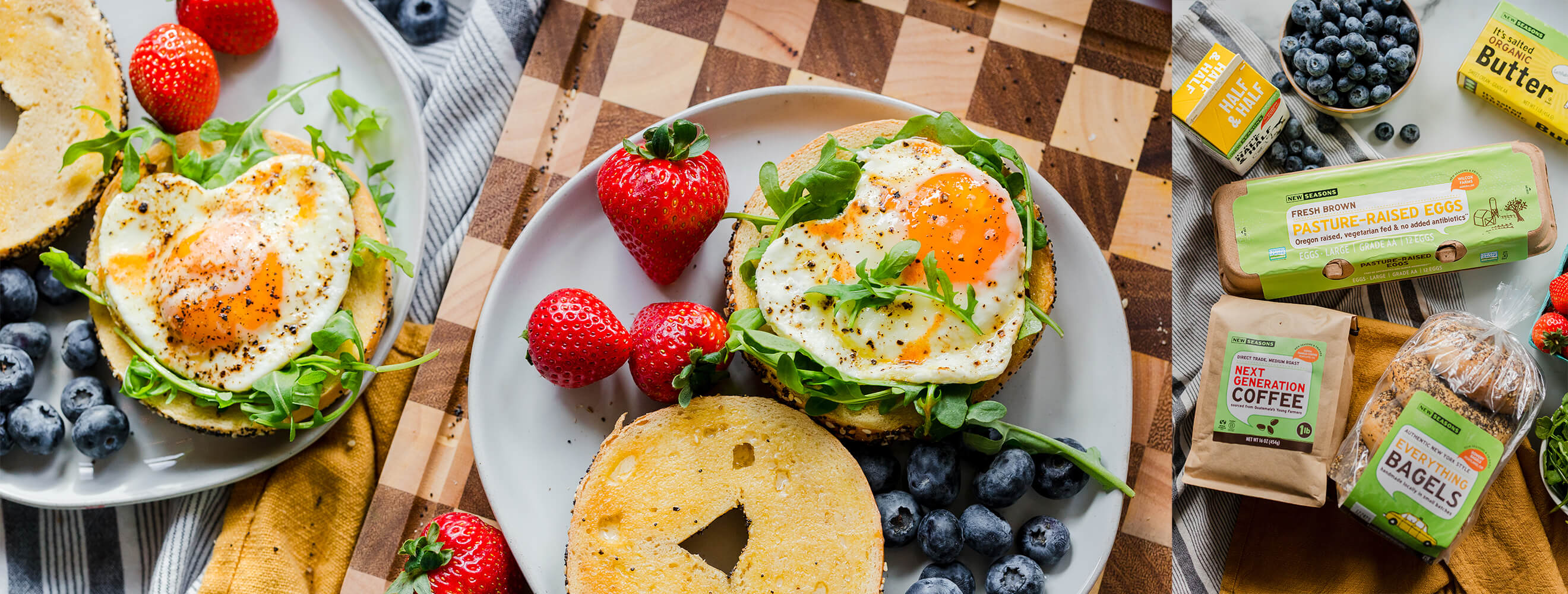 Shot of top a breakfast bagel sandwich served with berries along side a shot of New Seasons Brand products used to make it like coffee, eggs, bagels, butter and half and half.