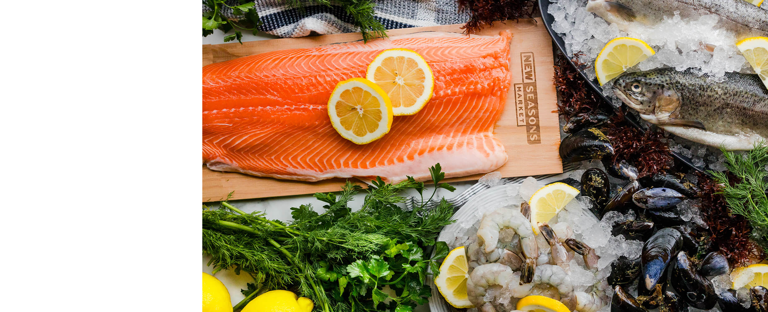 Top down image of an assortment of seafood including salmon, shrimp and mussels