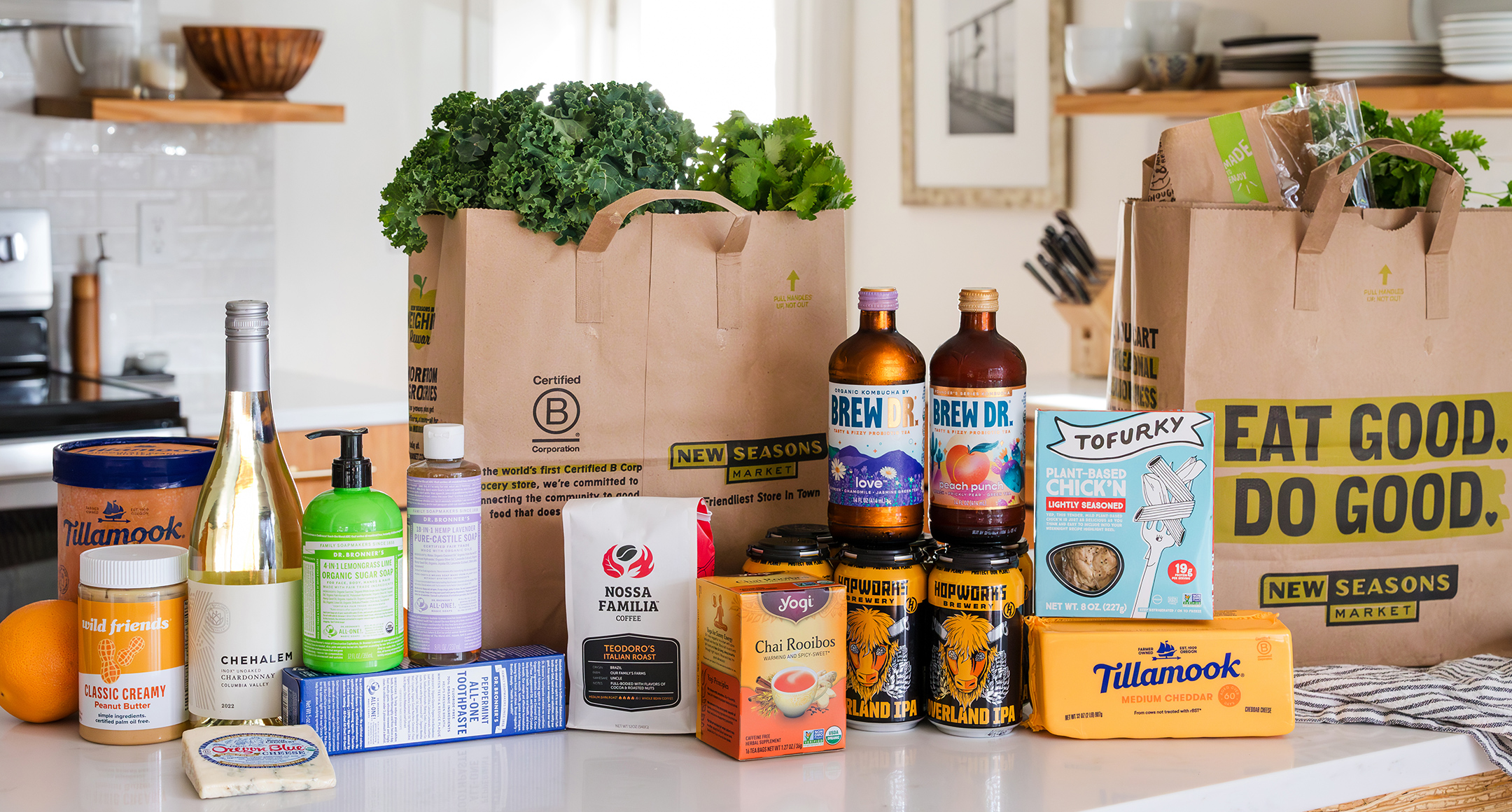 A countertop with New Seasons Market paper grocery bags and an array of B Corp products. 