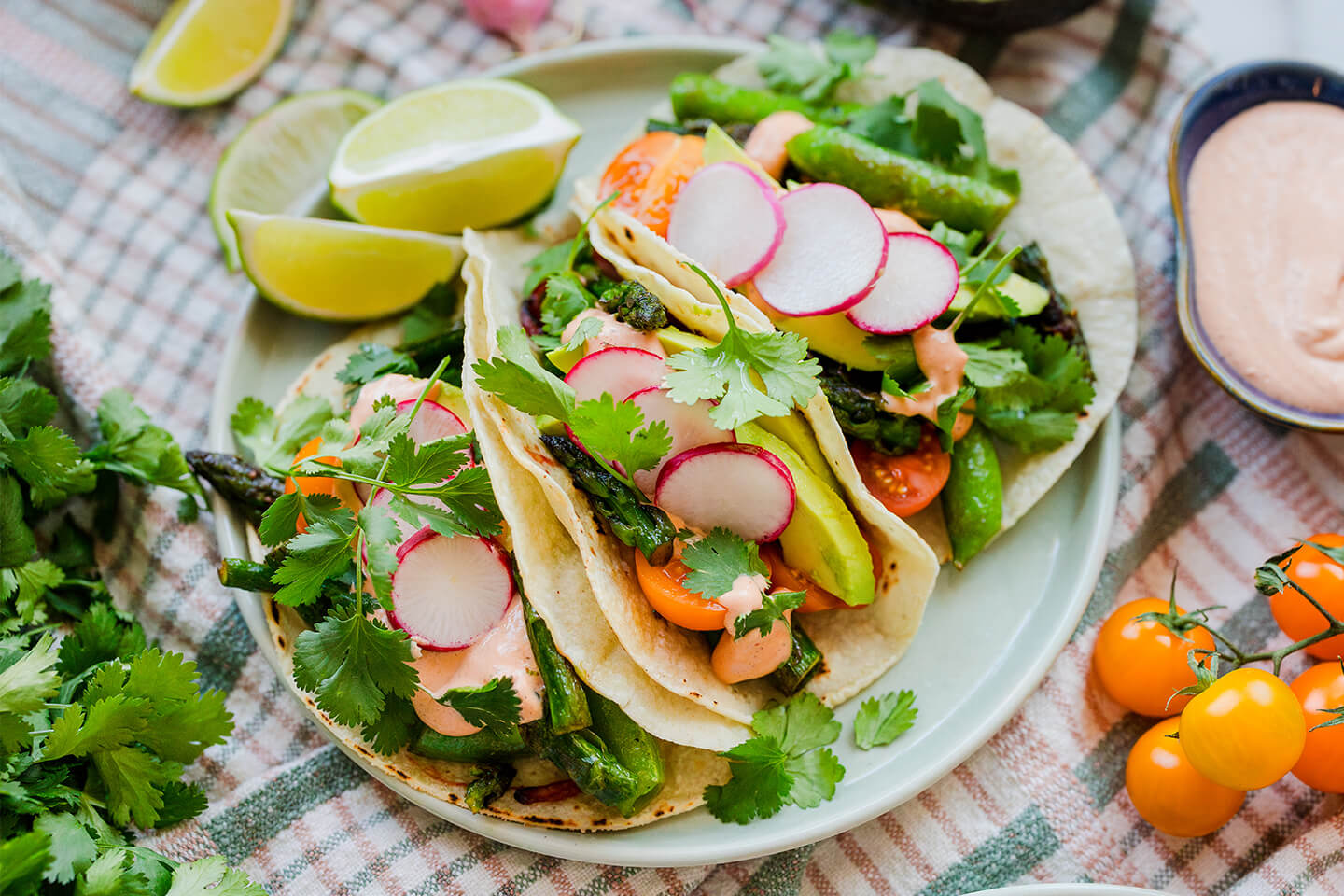 Three spring veggie tacos on a plate.