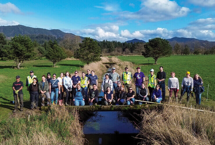 New Seasons and Tillamook staff volunteers posing for a group photo at the planting event. 