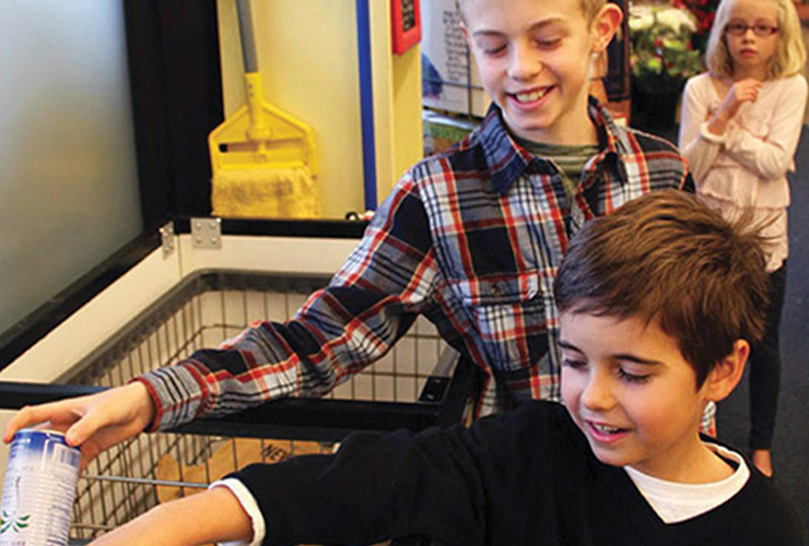 children donating bottles and cans towards the Cans for Kids program