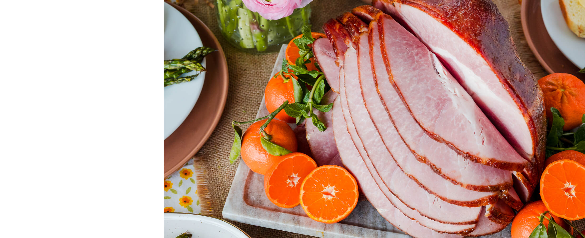An image of sliced ham with oranges