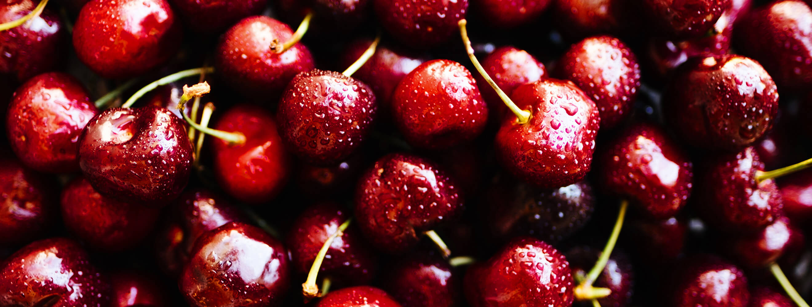 a closeup of fresh red cherries in a pile